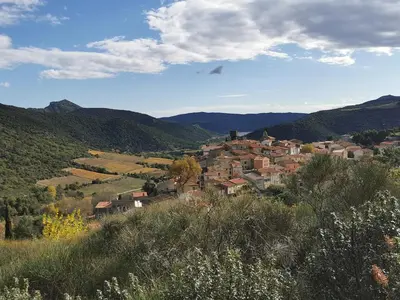 a small town in a valley with mountains at Le dôme géodésique in Ansignan