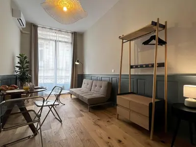 a living room with a couch and a loft bed at Cours République in Narbonne