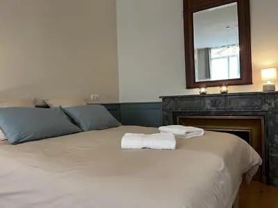 a bedroom with a bed with two towels on it at Cours République in Narbonne