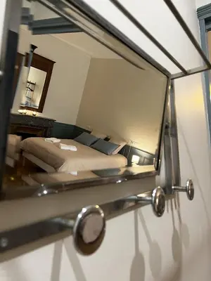 a reflection of a bedroom with a bed in a mirror at Cours République in Narbonne