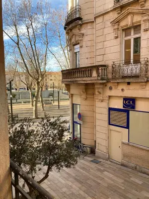 a building with a balcony on the side of it at Cours République in Narbonne