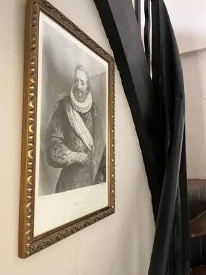 a framed picture of a man on a wall at La Halte Louis XIII in Bram