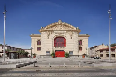 a large white building with a red door at Le Barral in Castres