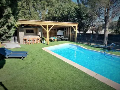 a backyard with a swimming pool and a gazebo at VILLA AU CALME AVEC PISCINE in Moussan