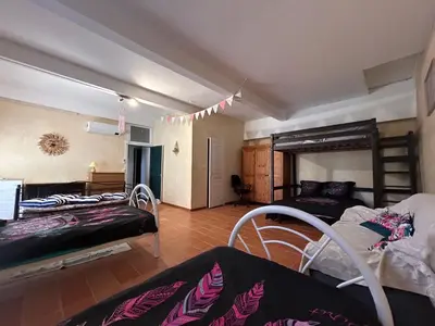 a room with two bunk beds and a bedroom at VILLA AU CALME AVEC PISCINE in Moussan