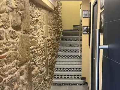 a staircase in a hallway with a stone wall at jouxtant le canal du midi in Trèbes