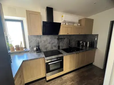 a kitchen with a sink and a stove top oven at jouxtant le canal du midi in Trèbes