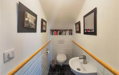 a bathroom with a white sink and a toilet at 5 Bedroom Beautiful Home In Ouveillan in Ouveillan