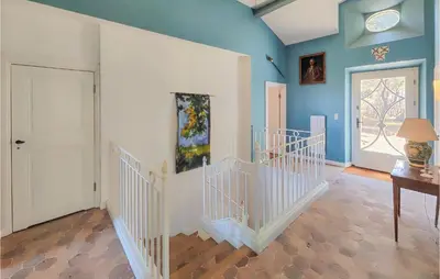 a room with blue walls and a white staircase at 5 Bedroom Beautiful Home In Ouveillan in Ouveillan