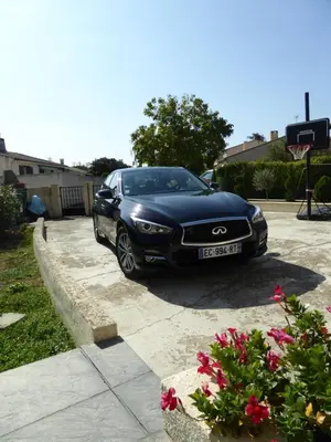 a black car parked in a driveway at Apartment The Address in Carcassonne