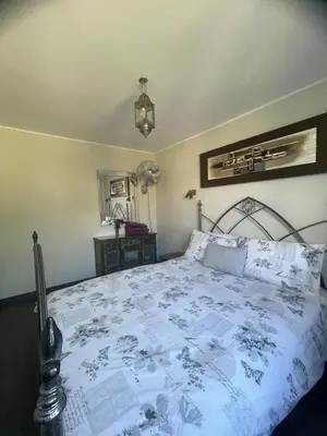 a bedroom with a bed with a blue and white comforter at Apartment The Address in Carcassonne