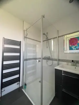 a bathroom with a glass shower and a sink at Apartment The Address in Carcassonne