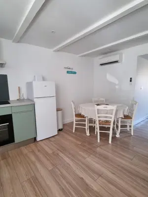 a kitchen and dining room with a table and chairs at Maison cosy rénovée, proche de Carcassonne in Villarzel-Cabardès