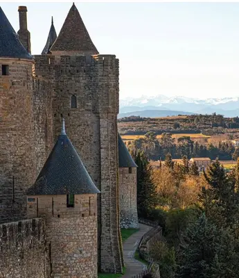 an old castle with turrets and a road at Maison cosy rénovée, proche de Carcassonne in Villarzel-Cabardès