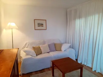 a living room with a white couch and a table at La Petite Romance - Gîte 3 étoiles in Siran
