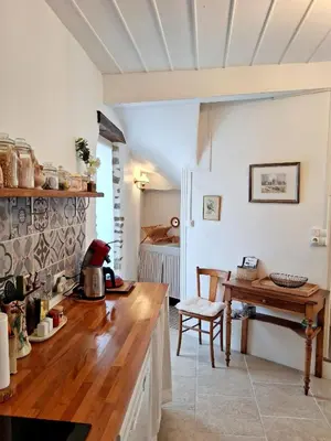 a kitchen with a wooden counter and a table at La Petite Romance - Gîte 3 étoiles in Siran