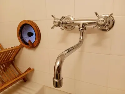 a bathroom with a shower head on a wall at La Petite Romance - Gîte 3 étoiles in Siran