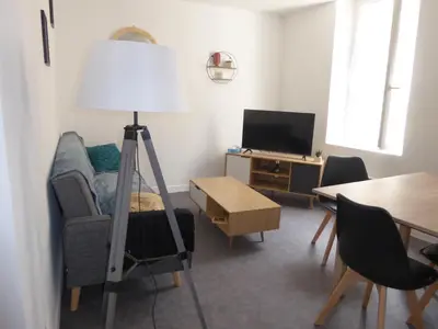 a living room with a lamp and a couch and a table at T1 Bis - Centre Historique de Narbonne in Narbonne