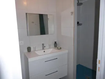 a white bathroom with a sink and a mirror at T1 Bis - Centre Historique de Narbonne in Narbonne