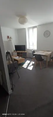 a room with a table and chairs and a television at T1 Bis - Centre Historique de Narbonne in Narbonne