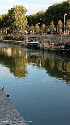 a group of boats docked in a body of water at T1 Bis - Centre Historique de Narbonne in Narbonne
