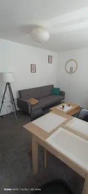 a living room with a couch and a table at T1 Bis - Centre Historique de Narbonne in Narbonne