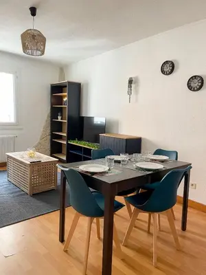a dining room with a table and blue chairs at Duplex calme & fonctionnel - Centre Narbonne - Idéal déplacements pro in Narbonne