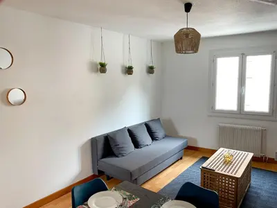 a living room with a couch and a table at Duplex calme & fonctionnel - Centre Narbonne - Idéal déplacements pro in Narbonne