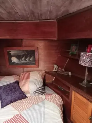 a bedroom with two beds and a desk with a lamp at Bateau de pirates in Gruissan