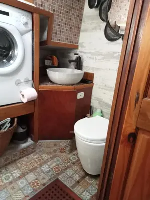 a small bathroom with a toilet and a sink at Bateau de pirates in Gruissan