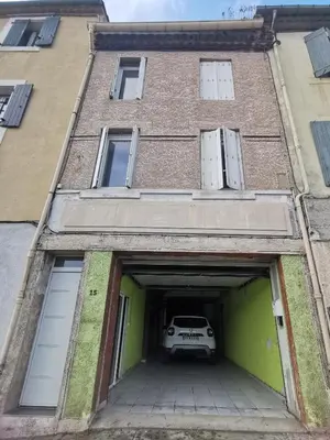 a car parked inside of a building with a garage at La maison de Marie - Jardin arboré - Garage privatif - Netflix in Carcassonne