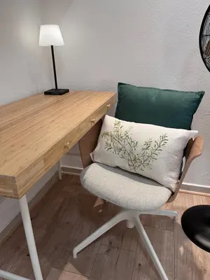 a desk with a chair with a pillow on it at Salut Le Petit Gite in Carcassonne