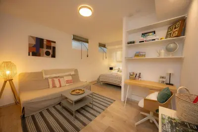 a living room with a couch and a table at Salut Le Petit Gite in Carcassonne