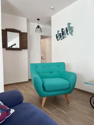 a living room with a green couch and a mirror at Tierra Del Viento - Villa Proche de la Mer in Peyriac-de-Mer