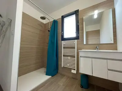 a bathroom with a shower and a sink and a mirror at Tierra Del Viento - Villa Proche de la Mer in Peyriac-de-Mer