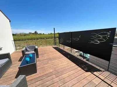 a wooden deck with a bench and a fence at Tierra Del Viento - Villa Proche de la Mer in Peyriac-de-Mer