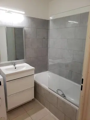 a bathroom with a tub and a sink and a mirror at les lys magiques in Carcassonne
