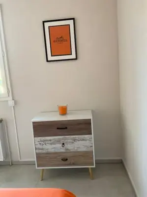 a dresser in a room with a picture on the wall at Villa Reine du Sud proche des Grands Buffets in Narbonne