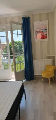 a bedroom with a bed and a large window at Villa Reine du Sud proche des Grands Buffets in Narbonne