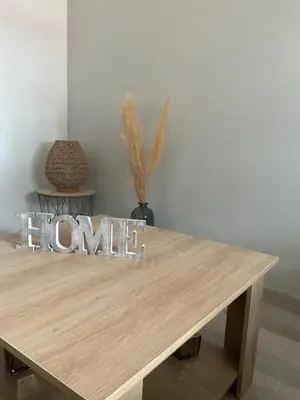 a wooden table with a home sign on top of it at Villa Reine du Sud proche des Grands Buffets in Narbonne