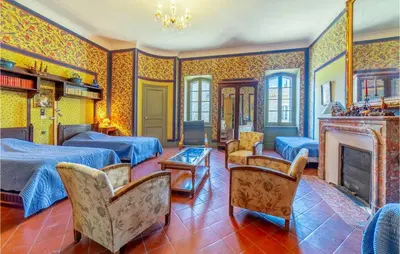 a living room with two beds and a fireplace at Amazing Home In Lézignan-Corbières in Lézignan-Corbières