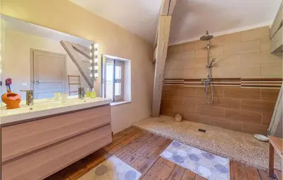 a bathroom with a shower and a sink and a mirror at Amazing Home In Lézignan-Corbières in Lézignan-Corbières