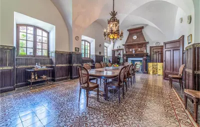 a dining room with a table and chairs and a chandelier at Amazing Home In Lézignan-Corbières in Lézignan-Corbières