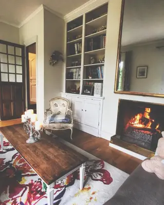 a living room with a fireplace and a table at Chambres d'Hôtes Domaine du Hameau Baylesse in Saint-Jean-dʼAigues-Vives
