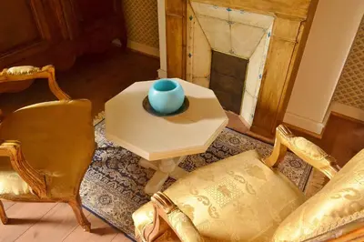 a living room with a table and chairs and a vase at Chambres d'Hôtes Domaine du Hameau Baylesse in Saint-Jean-dʼAigues-Vives