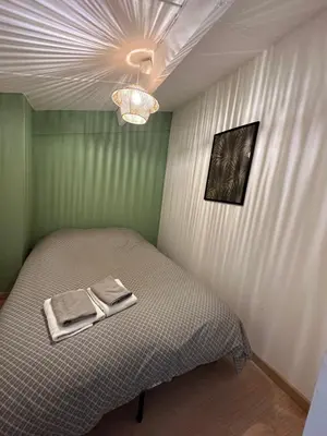 a bedroom with a bed with two towels on it at La Mezza de Gruissan in Gruissan