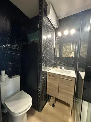 a bathroom with a white toilet and a sink at La Mezza de Gruissan in Gruissan