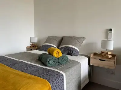 a bedroom with a bed with two pillows on it at Studio - Centre de Villefranche de Lauragais in Villefranche-de-Lauragais