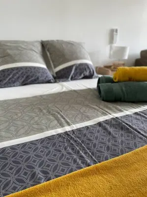 a bed with two pillows on top of it at Studio - Centre de Villefranche de Lauragais in Villefranche-de-Lauragais