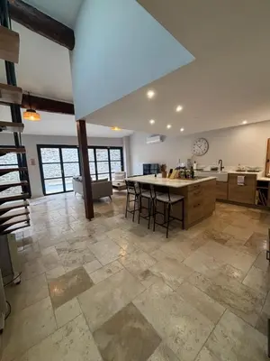a large kitchen with a large island in a room at Hidden Oasis - Maison de caractère avec piscine in Azille